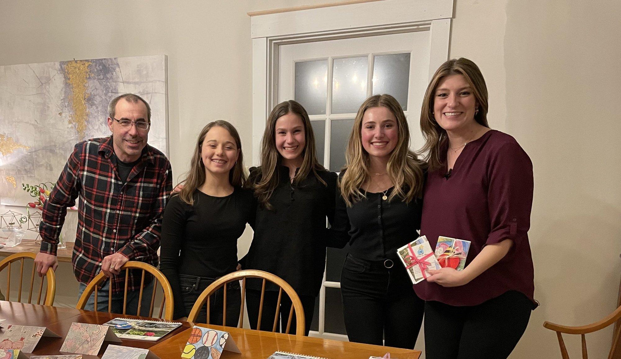 The Gratitude for Maine team holding their note cards