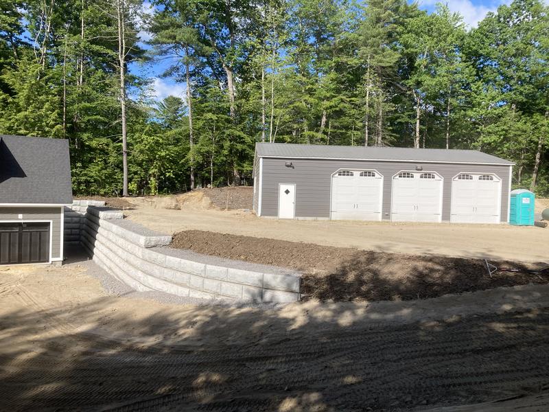 Boulder retaining wall in a Maine landscape