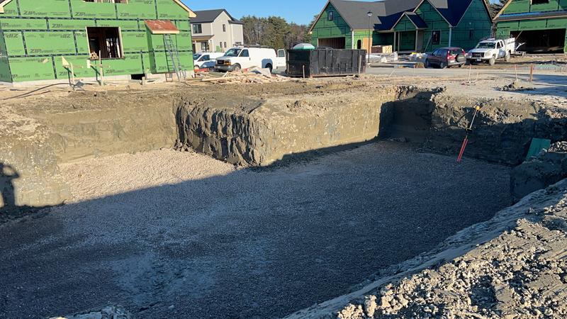 Excavator preparing a foundation site