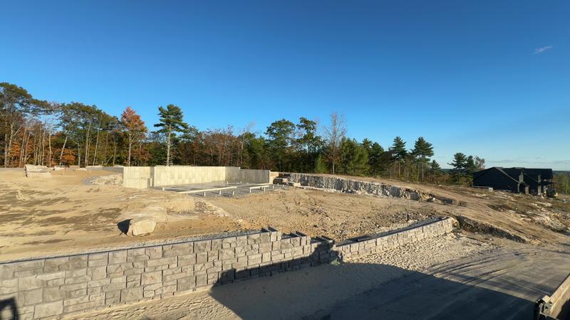 Stacked stone retaining wall installation