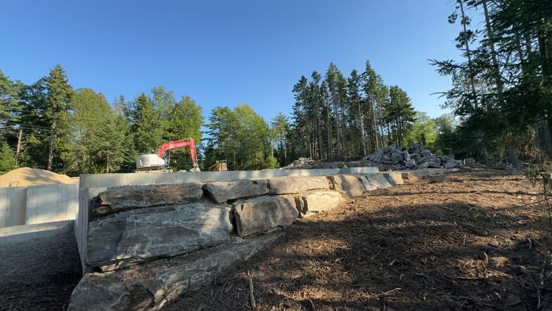 Stacked stone retaining wall installation