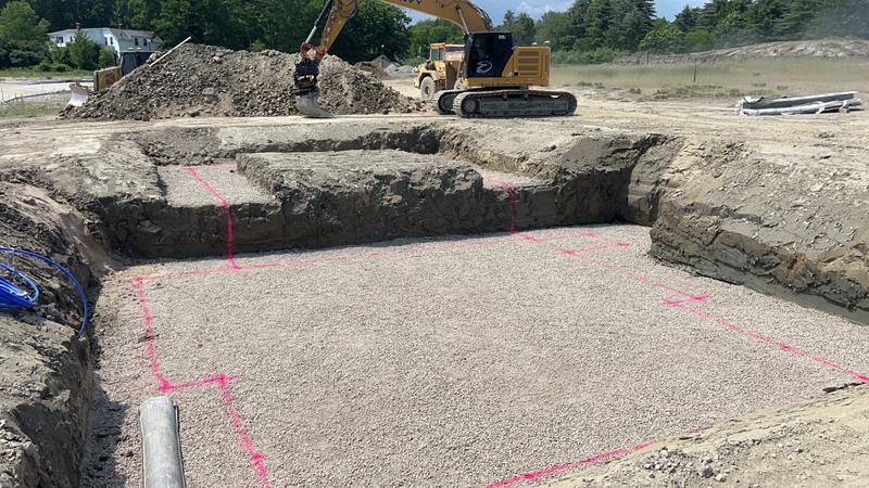 Excavator preparing a foundation site