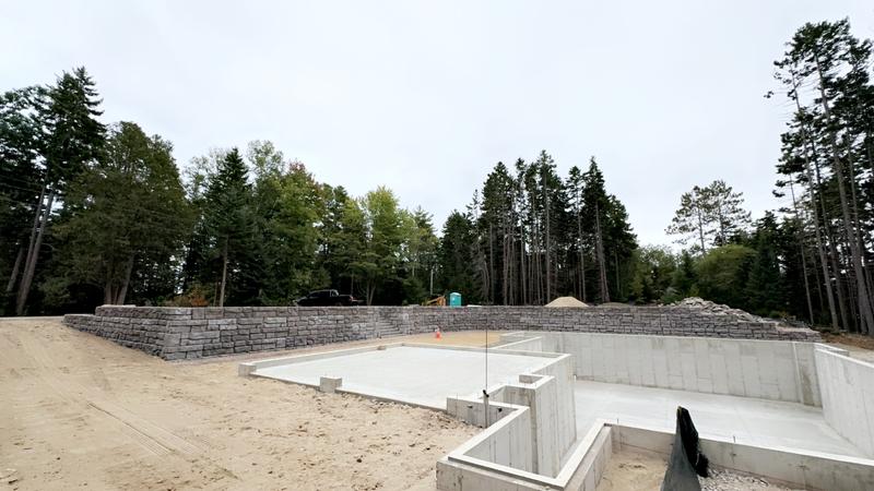 Stacked stone retaining wall installation