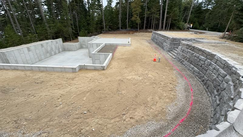 Boulder retaining wall in a Maine landscape