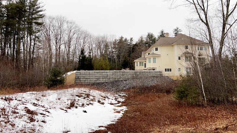 Stacked stone retaining wall installation