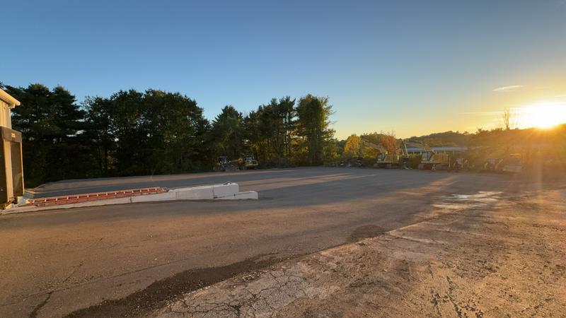 Excavator shaping a residential driveway