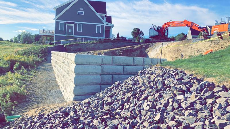 Boulder retaining wall in a Maine landscape