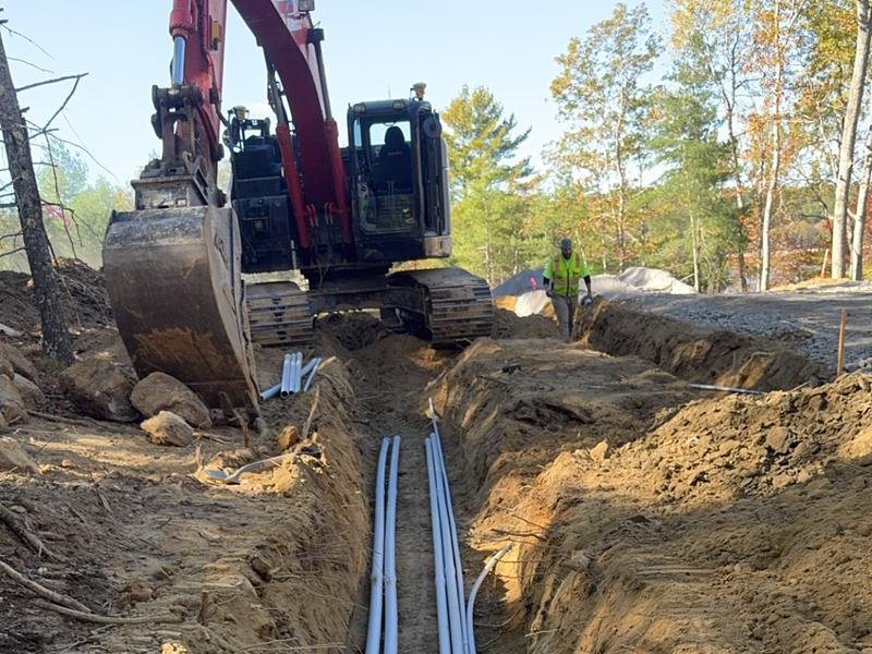 Multiple excavators working roadside utilities