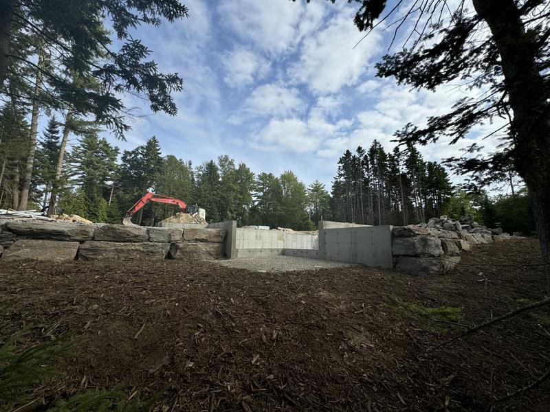 Stacked stone retaining wall installation