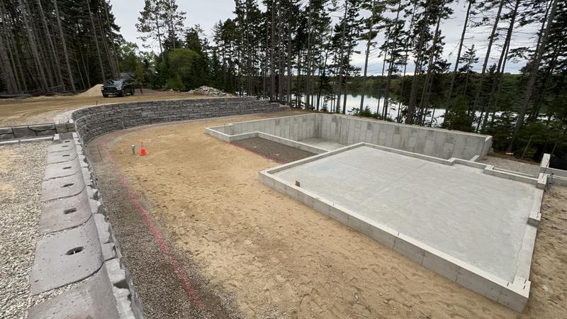 Stacked stone retaining wall installation