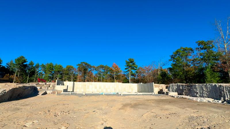 Boulder retaining wall in a Maine landscape