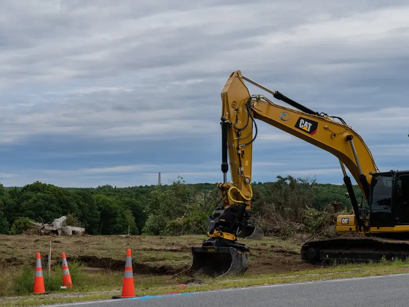 Excavator clearing land