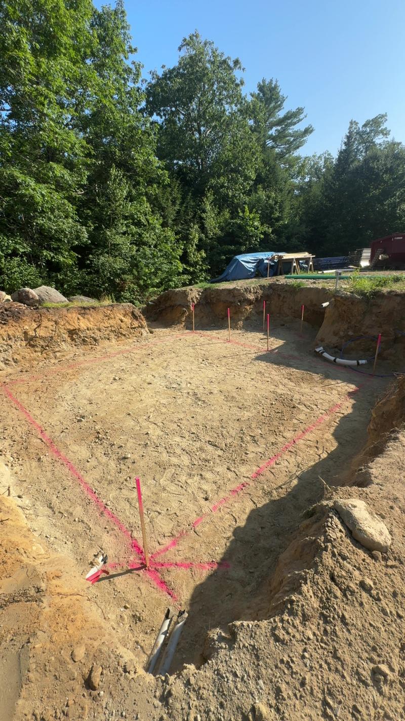 Excavator preparing a foundation site