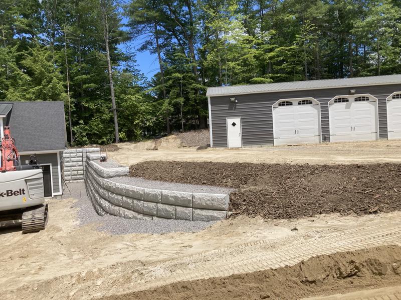 Stacked stone retaining wall installation