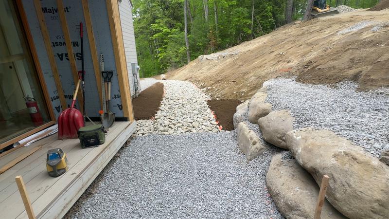 Boulder retaining wall in a Maine landscape