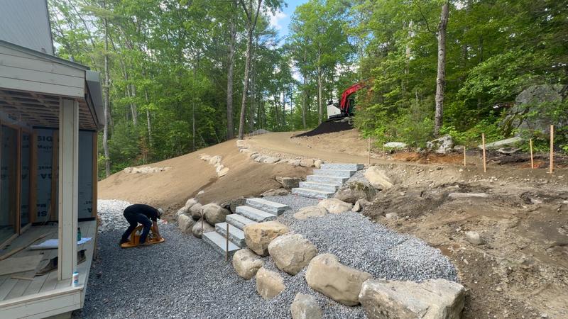 Boulder retaining wall in a Maine landscape