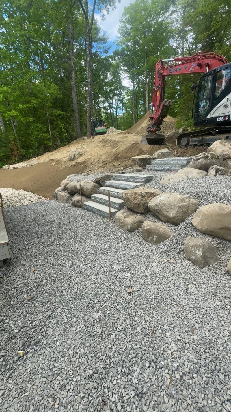 Stacked stone retaining wall installation