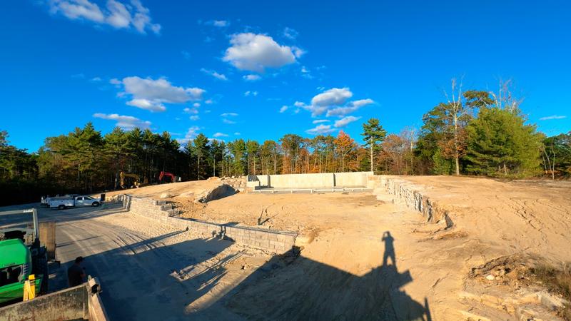 Boulder retaining wall in a Maine landscape