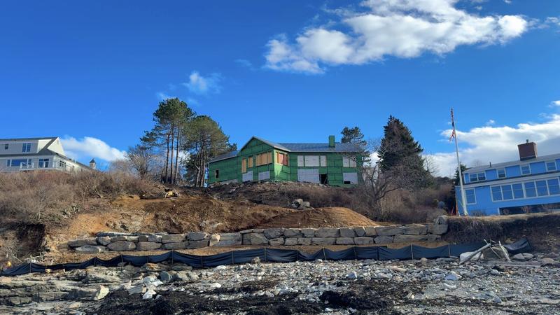 Boulder retaining wall in a Maine landscape